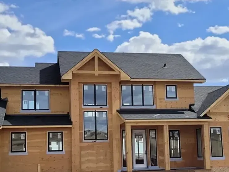 Home being built. Large windows and wood showing. Regina, Saskatchewan.